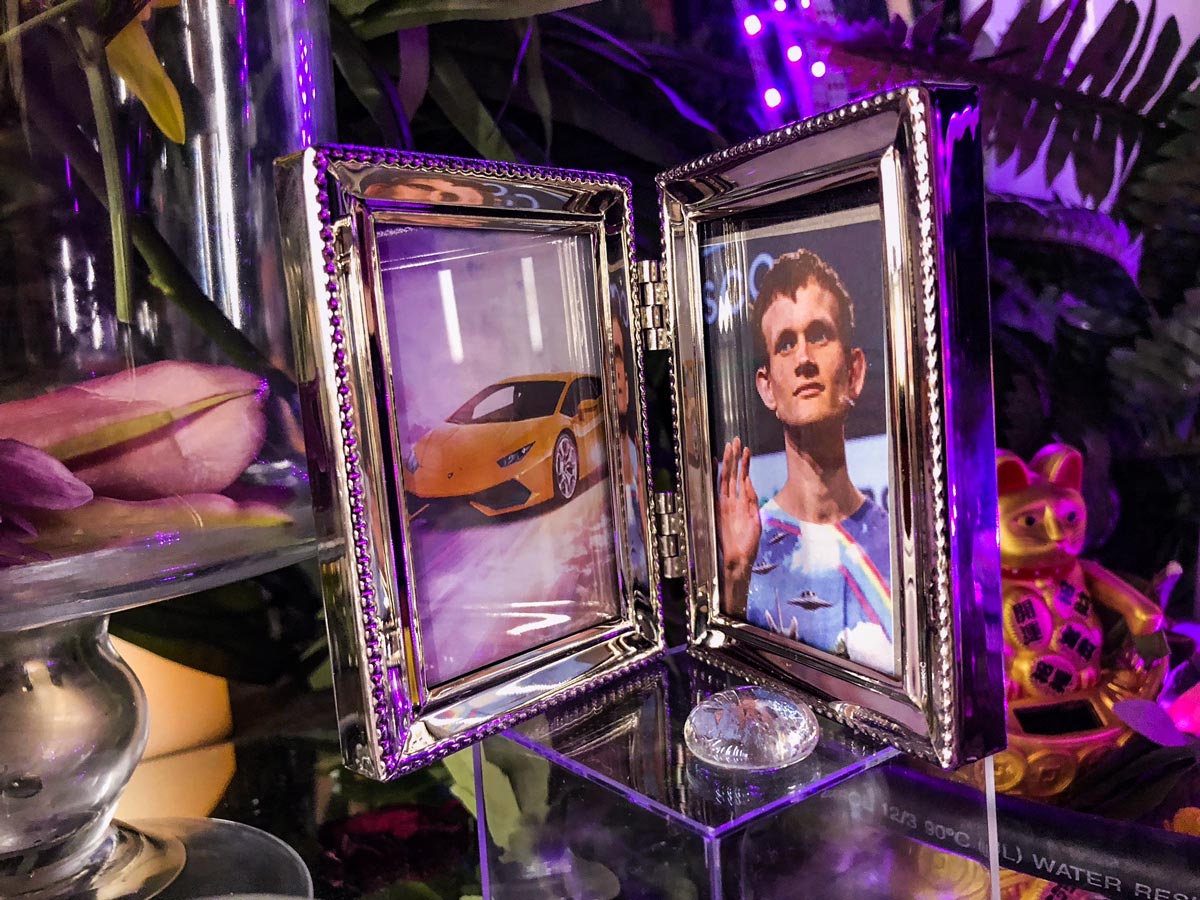 Facing photo frames of Vitalik and his Lambo